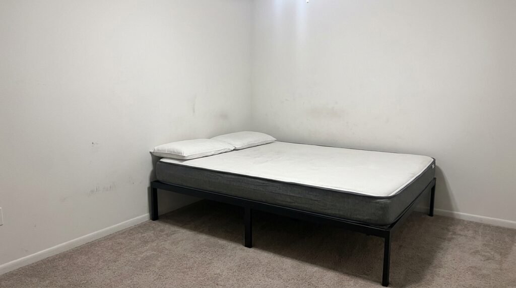DIY fabric headboard mounted on bedroom wall behind a low profile bed